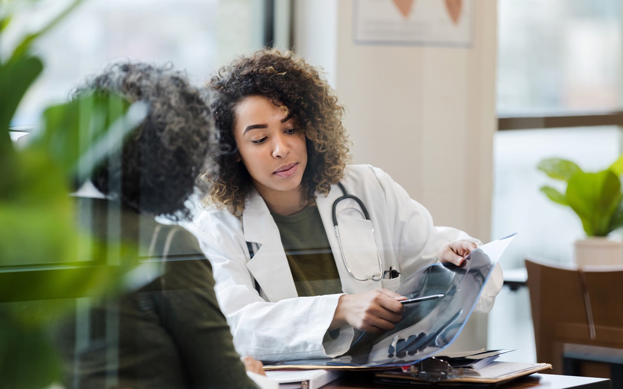 A doctor reviewing x-rays with a patient