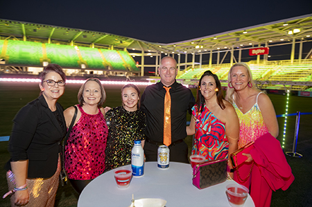 group of people on the field with yellow lights