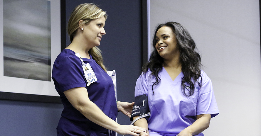 nurse with corporate wellness patient