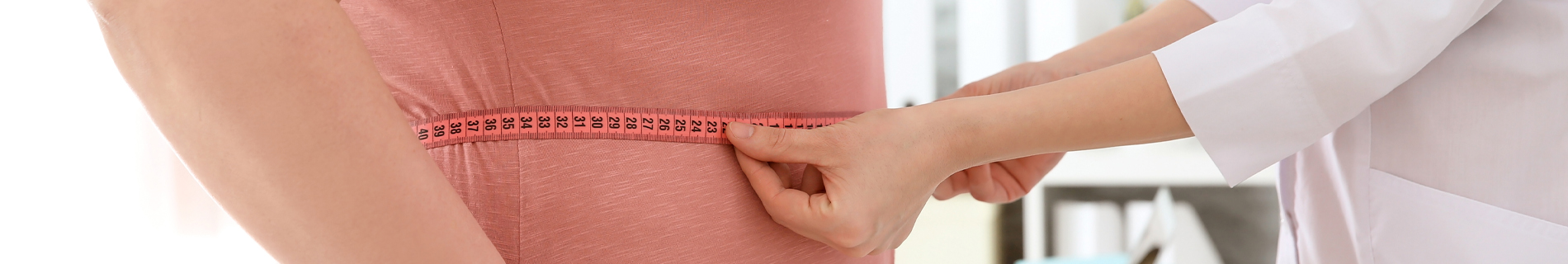 Someone measuring a person's stomach