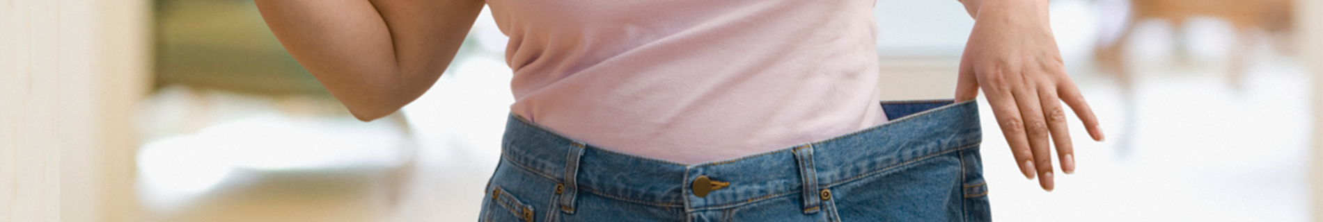 A woman wearing pants with a waist wider than her own
