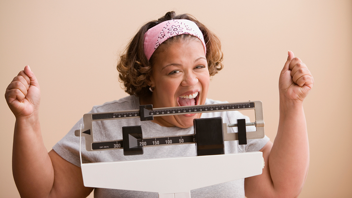 Happy woman on scale