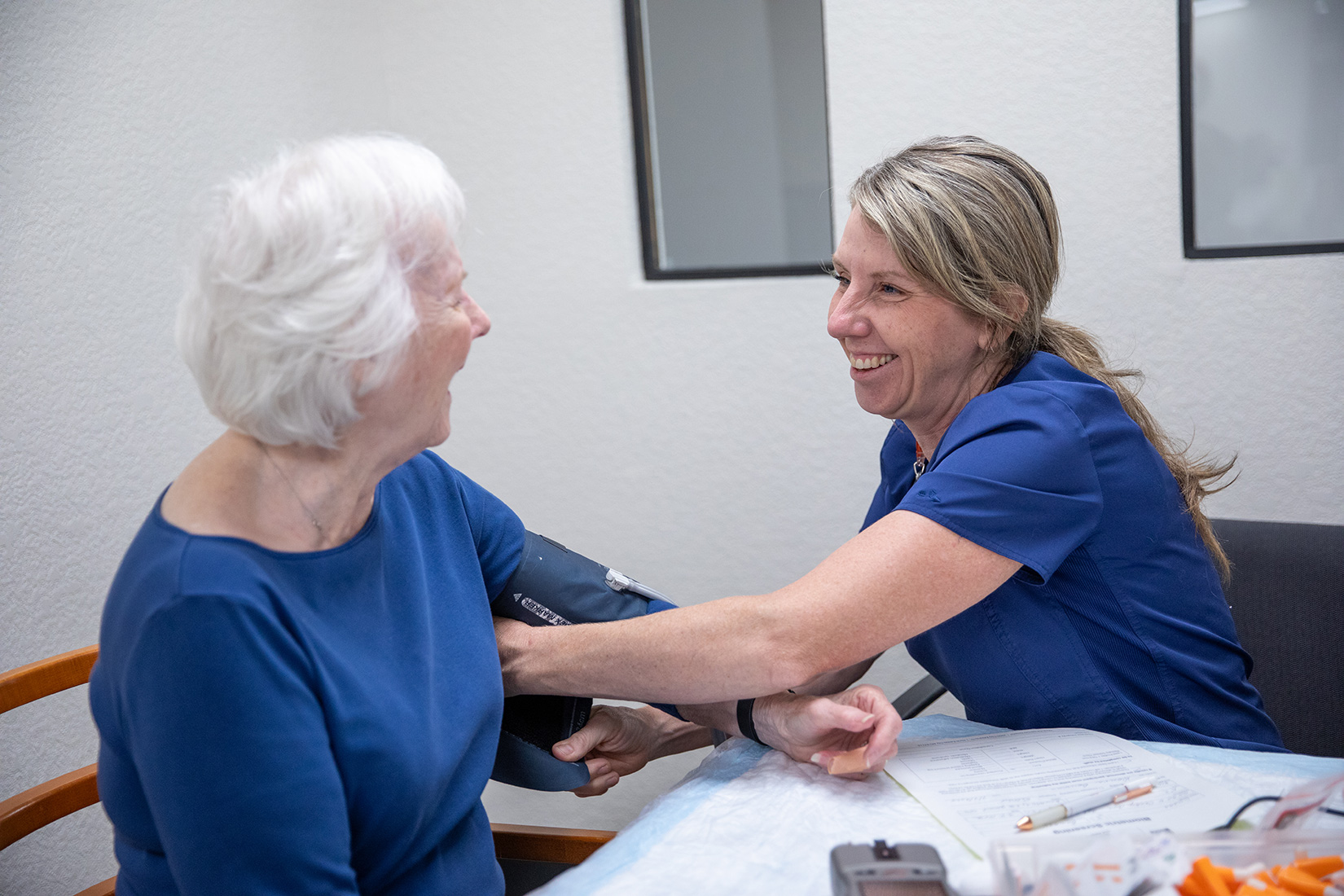 Woman having her blood pressure taken at free health screening
