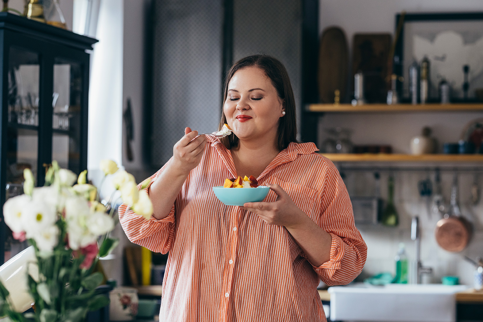 Overweight woman eating healthy breakfast