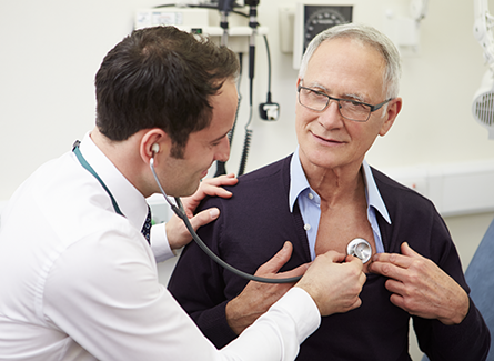Doctor checking senior patient with stethoscope