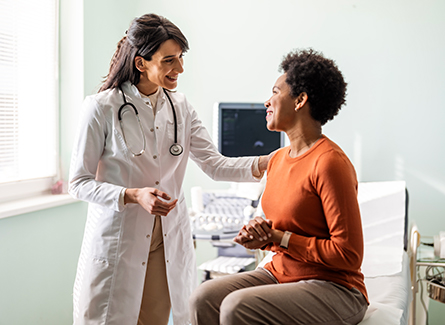 Female doctor speaking to female patient