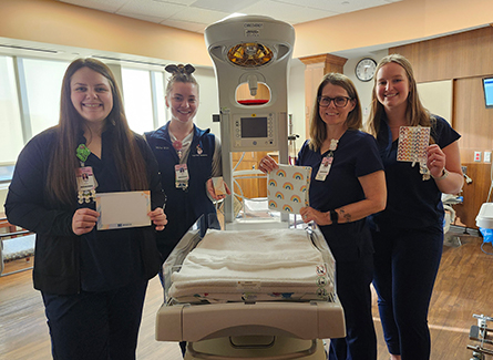 Maternity nurses with rainbow baby blankets