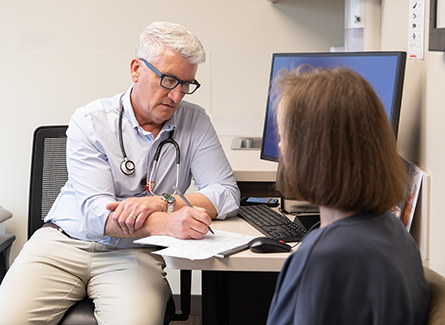 Steven Kaster, MD, consulting with patient.
