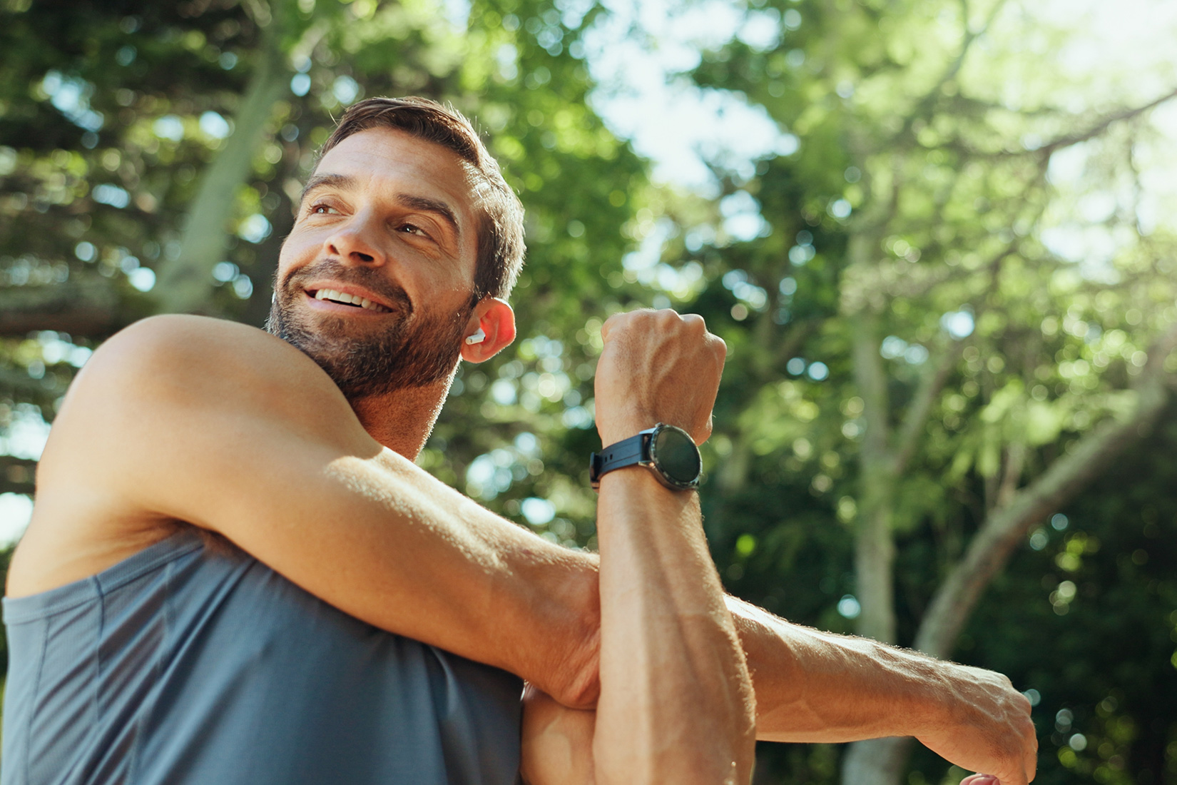 Man stretching and smiling