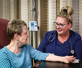 Nurse helping cancer patient with infusion treatment