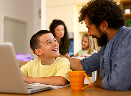 Father and son working at kitchen table