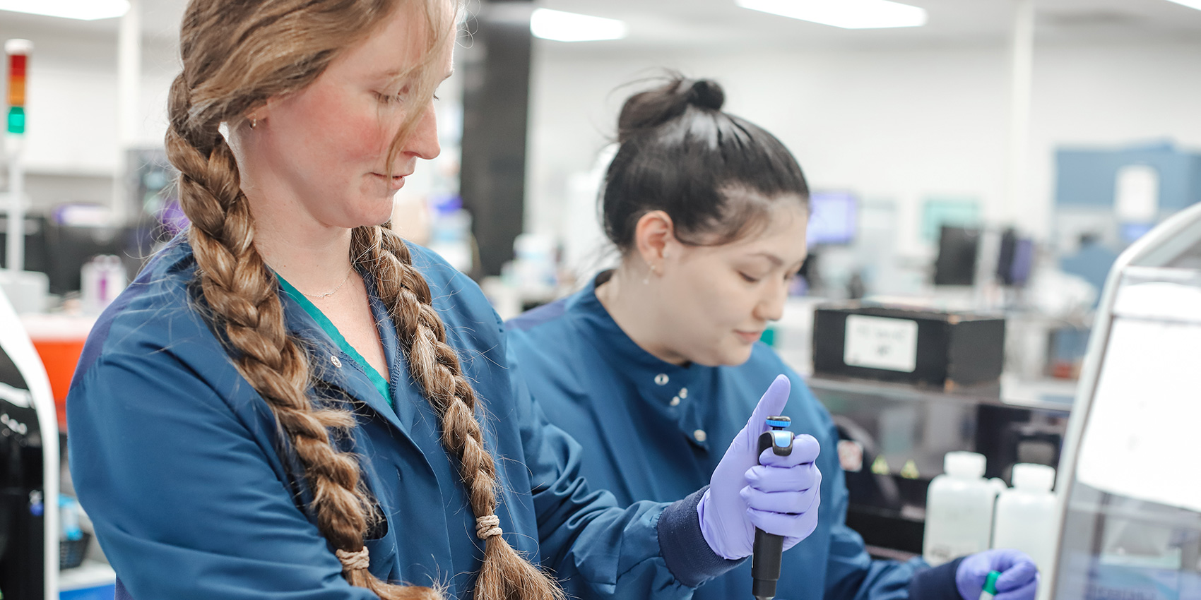 Two women working in NKC Health lab