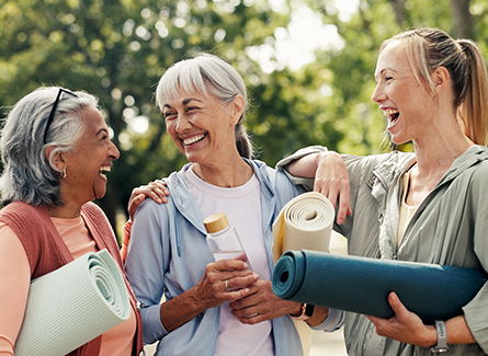 Women laughing together at yoga in the park