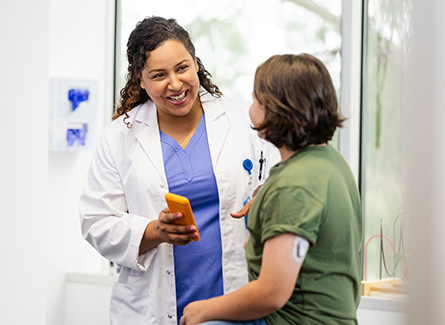 Woman with glucose monitor speaking to doctor
