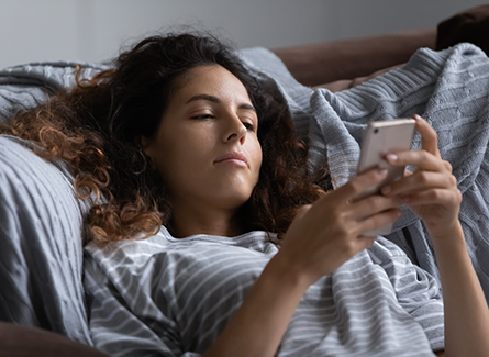 Woman looking depressed on her phone