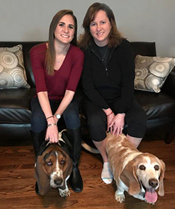 Mom Becky Smith, with Hank, and Molly Spencer, with George, share a love for basset hounds and nursing.