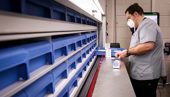 Dylan Reno, Pharmacy tech, uses a new automated medication dispensing storage and retrieval carousel