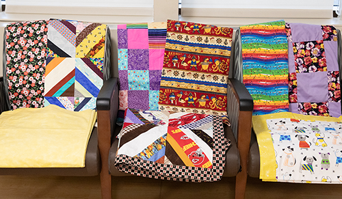 Display of colorful Project Linus blankets