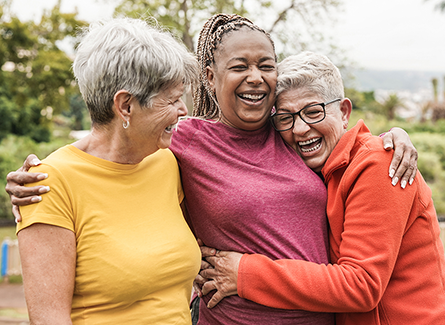 Three older women hugging